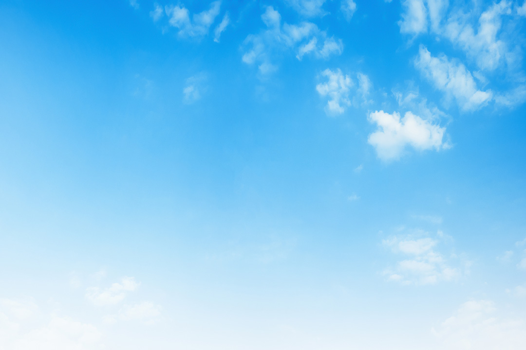 The image shows a clear blue sky with a few scattered clouds, viewed from below as if looking up.