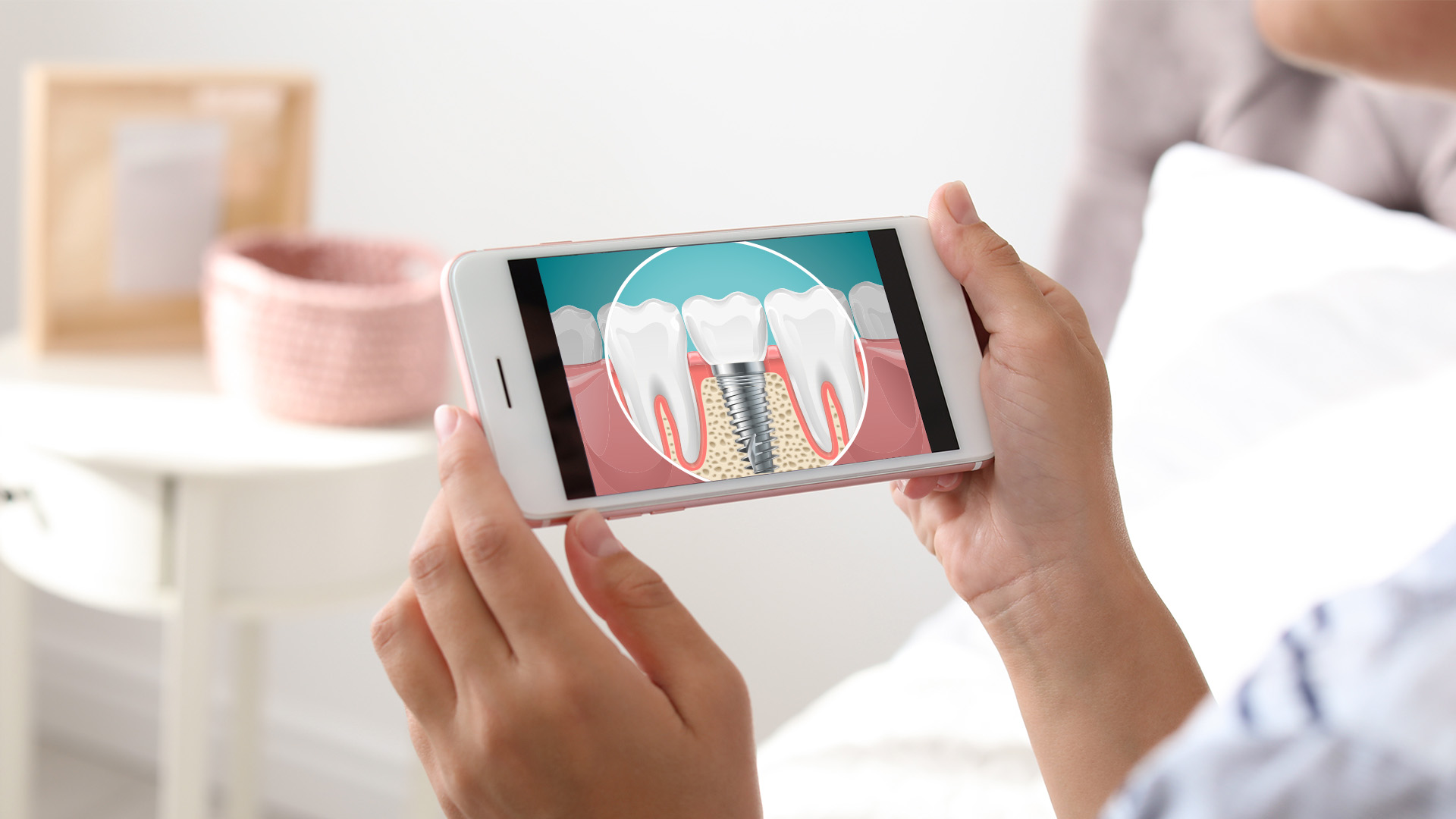 A person holding a smartphone displaying an image of a tooth with a crack, possibly in the context of dental care or education.