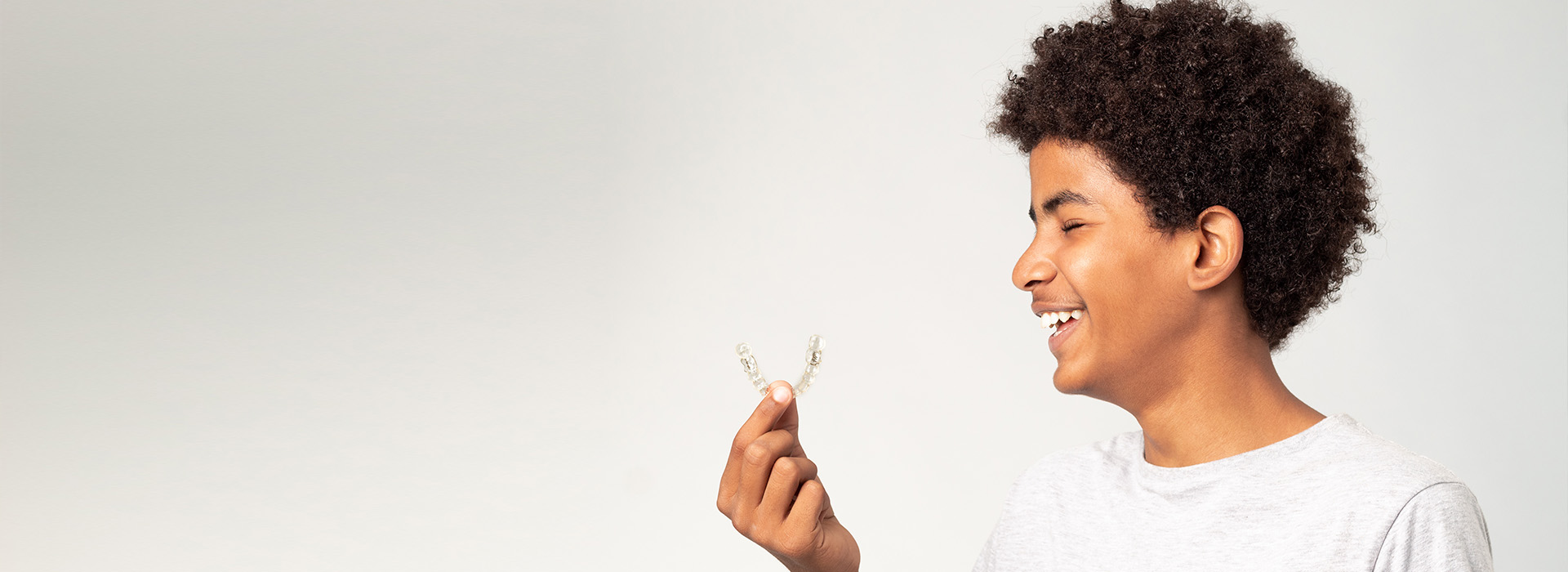 A person holding a flower with a joyful expression.