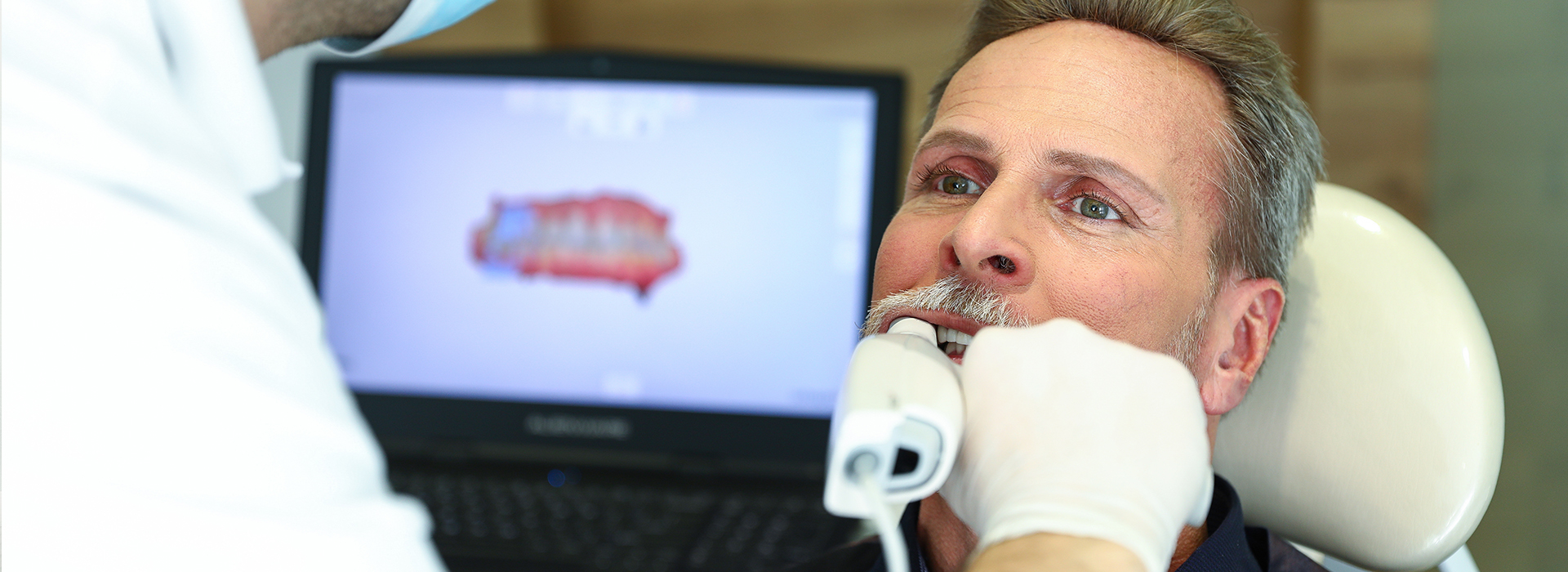 A person receiving dental care, with a dental professional working on their teeth.